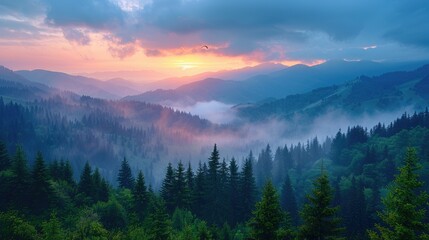 Obraz premium A scenic view of a mountain range with fog rolling through the valleys at sunrise.