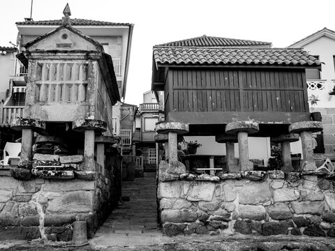 four horreos by the sea lit up at night in combarro, galicia