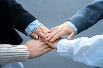 Business team with hands on each other, togetherness, team spirit, cooperation, business concept