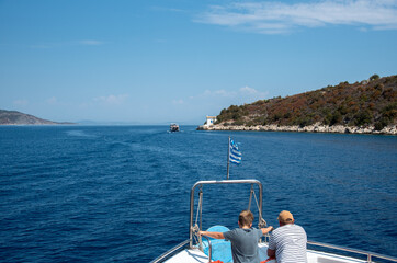 Obraz premium Father and son enjoying a boat trip in the greek islands
