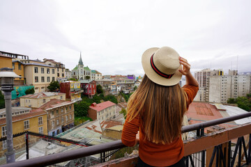 Naklejka premium Young tourist woman visiting the historic center of Valparaiso city, UNESCO World Heritage, Chile, South America