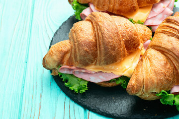 Croissant sandwich with salad ham and cheese . Top view