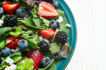 Berries salad (blueberry strawberry blackberry ) with cheese feta and balsamic sauce