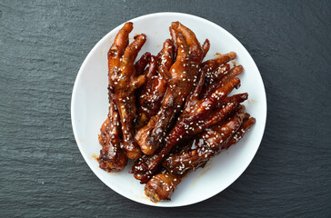 Caramelized korean or Chinese chicken foots ( paws ) with sesame . Top view