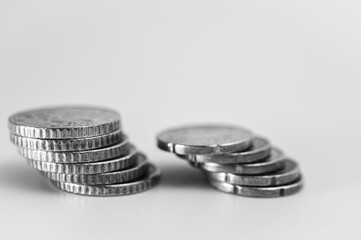 black and white photo, Close-up of a 20, 50 euro cent coin on a white background. The bright gold color and shallow depth of field make the coin's details, like the embossed numbers and map, pop. 