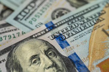 Close-up of a US one hundred dollar bill, background, Benjamin Franklin's meticulous eye, banknote. Detailed texture and high contrast highlight the intricate design, finance and currency themes 