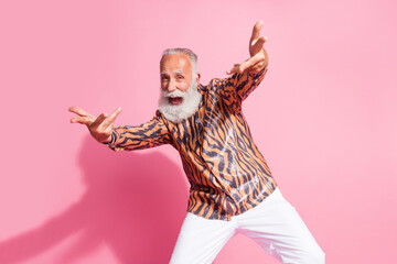 Photo of crazy funky grandfather make dancing gesture enjoy clubbing wear shiny glamour shirt isolated pink color background