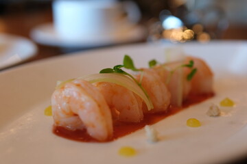 POACHED SHRIMP horseradish, meyer lemon, spicy cocktail sauce. restaurant serving luxury hotel food chic plate white decorations