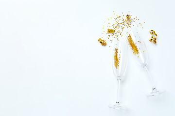 Festive background with champagne glasses and confetti, copy space composition