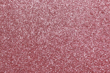 Fototapeta premium Pink glitter texture sparkling shiny wrapping paper background for Christmas holidays seasonal wallpaper decoration, greeting and wedding invitation design element