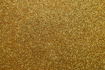Golden glitter texture sparkling shiny wrapping paper background for Christmas holidays seasonal wallpaper decoration, greeting and wedding invitation design element