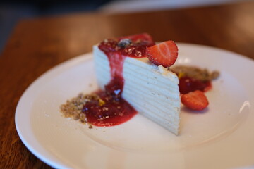 thin cakes with cream white cake thin cakes many layers with strawberry jam eat with a spoon from a...