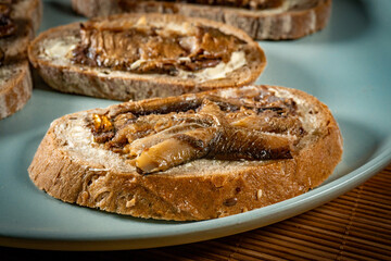 Slices of multigrain bread with sprats.