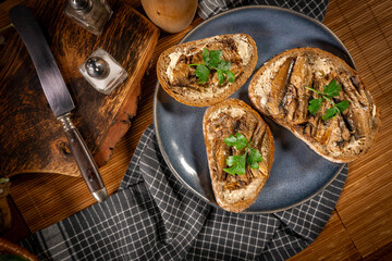 Slices of multigrain bread with sprats.