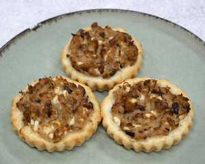 Gourmet mini tarts. Closeup view of fresh baked tuna fish pies