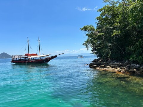 Escuna ancorada pr&oacute;ximo a ilha na lagoa azul em Angra dos Reis no Rio de Janeiro