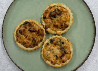 Gourmet mini tarts. Top view of fresh baked smoked salmon pies