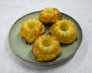Closeup view of fish and pumpkin muffins in a dish on the white table