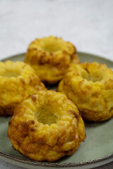 Closeup view of fish and pumpkin muffins in a dish on the white table