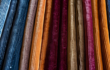 Fototapeta na wymiar Colorful vertical fabric stripes arranged in a creative pattern in daylight