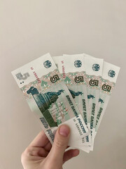 Russian rubles, money in hand, banknotes white background, Inflation concept