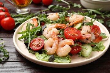 Delicious shrimp salad with vegetables on wooden table, closeup