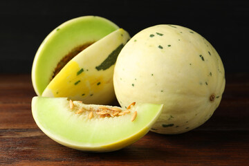 Fresh ripe honeydew melons on wooden table