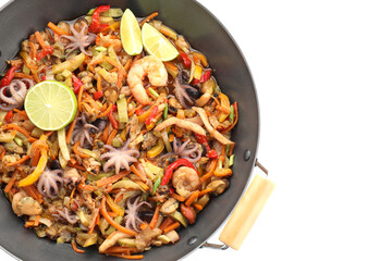 Stir-fry sea food in wok isolated on white, top view