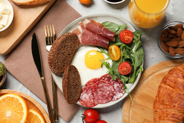 Different tasty food served for brunch on grey marble table, flat lay