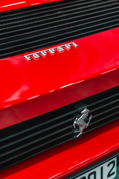 Red Ferrari Testarossa rear end silver badge closeup, Classic supercar rear engine grill with chrome lettering