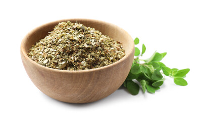 Dried oregano in bowl and green leaves isolated on white