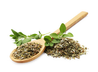Dried oregano, green leaves and wooden spoon isolated on white