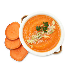 Delicious sweet potato soup with pumpkin seeds in bowl and fresh vegetable isolated on white, top view