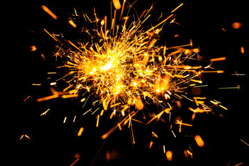 Christmas sparkle on black background. Bengal fire sparkle. Abstract golden fire sparkle isolated on a black background. New year sparkle on black background.