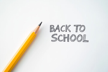 Bright yellow pencil beside handwritten text about returning to school