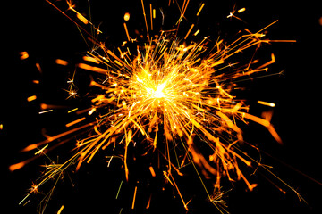 Sparkler background. New year sparkler on black background. Bright sparkles background. Christmas...