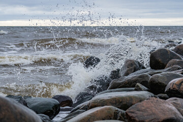 Splashes from the waves bumping against the rocky shore.