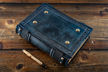 medieval old blue leather book lay down to the wooden table