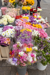 Table full of flowers with a variety of colors and types