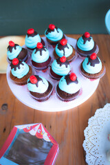 Blue velvet creamy cupcakes on a wooden shelf in a party