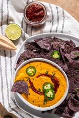 Corn tortilla chips with queso and jalepnos 