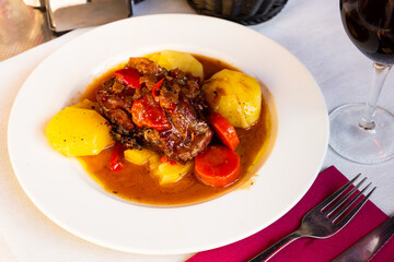 Roasted mutton shoulder served with gravy and vegetable stew