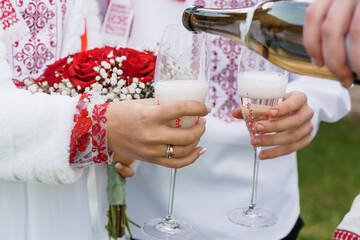 Celebration of Love: A Toast with Champagne and Beautiful Flowers in Traditional Attire