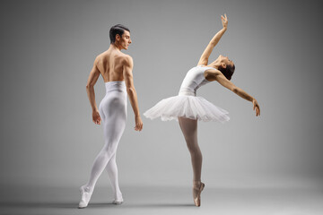 Male and female ballet dancers in white clothes