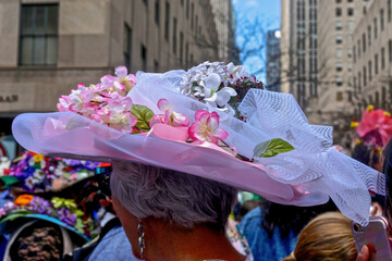 New York, New York: A woman wearing a pink and white flowered Easter bonnet at the annual Fifth Avenue Easter Parade.