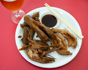 Cooked boiled duck head, duck legs and duck wings with sauce. Chinese cuisine
