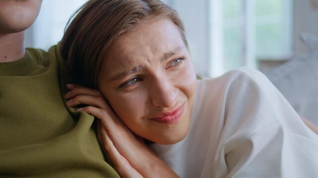 Scared girlfriend bonding boyfriend watching horror sofa closeup. Woman afraid