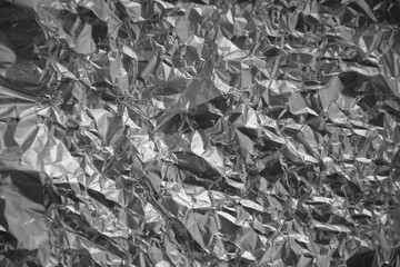 Processed collage of shiny metal silver gray foil crumpled packaging material texture