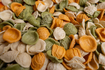 Raw pasta background close up. Different types of pasta and noodles on color background. Italian cuisine culinary concept. Collection of different raw pasta on cooking table
