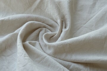 Grey textile napkin in white color as background. Folded decorative kitchen cotton towel